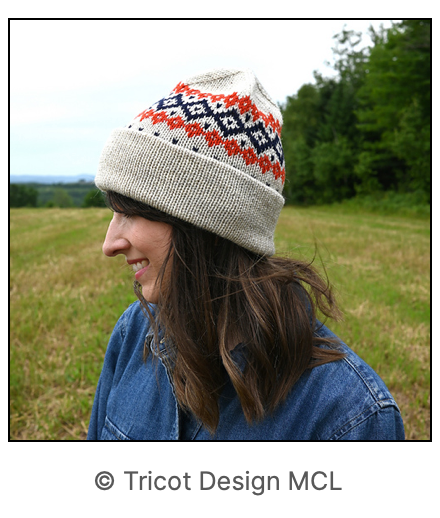 image of the knit hat in beige, red and blue being worn on a woman outdoors