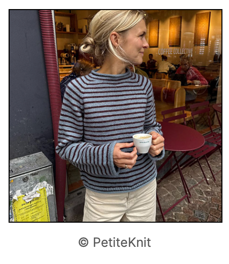 Image of a woman holding a mug/cup wearing a striped knit sweater in blue and grey