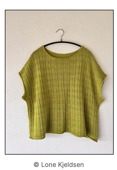 The Hør No 19 on a clothes hanger in the colour yellowish green