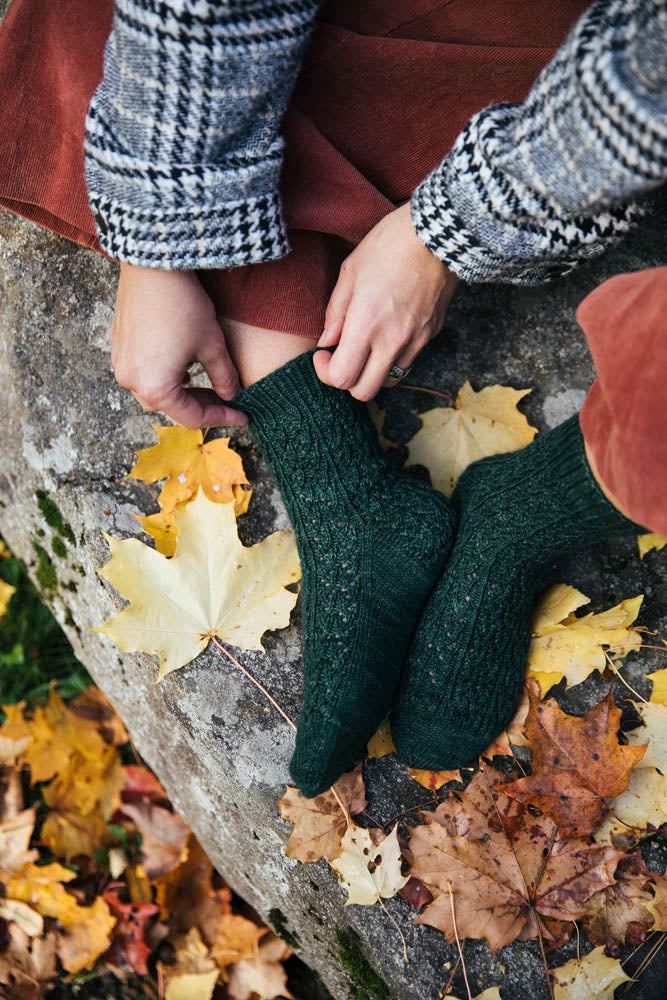 image of socks being worn on a person.  can only see feet and hands
