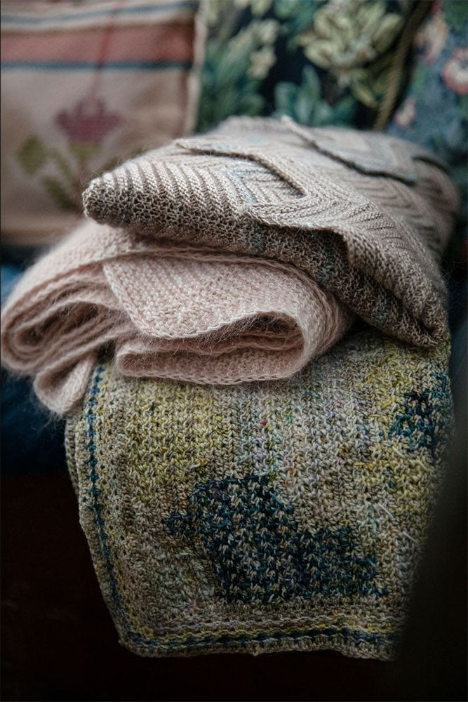 a stack of 3 folded shawls