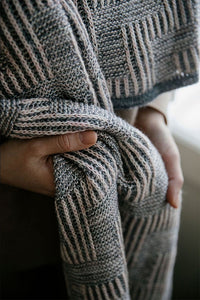 up close picture of hands holding a shawl