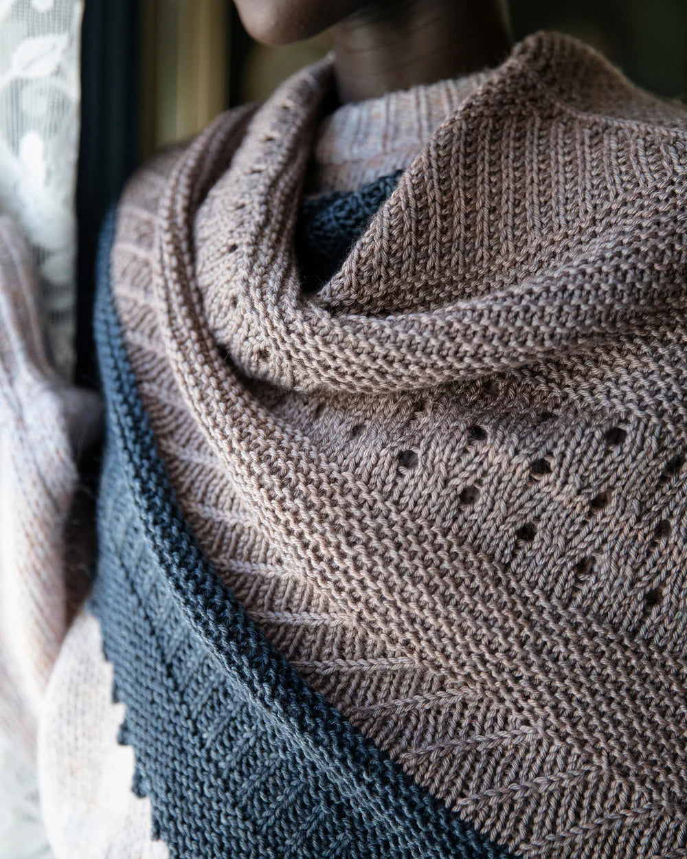close up of a shawl near a window