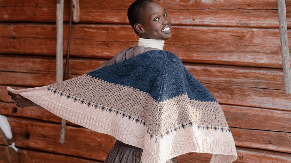 shawl on a person who is standing with their back to the camera but looking over their shoulder