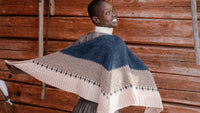 shawl on a person who is standing with their back to the camera but looking over their shoulder