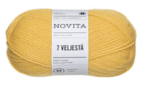 Yellow ball of Novita yarn with label on a white background