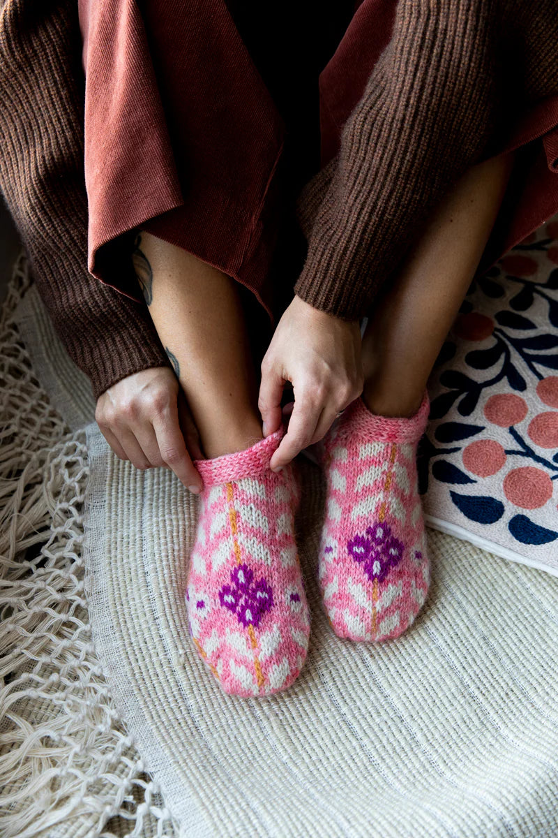 image of colourwork knit slippers being put on a person