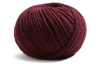 deep red ball of yarn on a white background