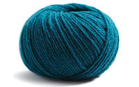 teal coloured ball of yarn on a white background