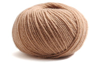 nude colour ball of yarn on a white background