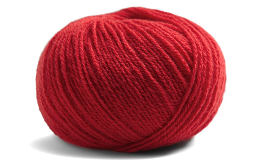 red coloured ball of yarn on a white background