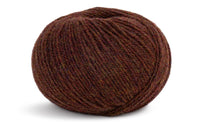 medium brown coloured ball of yarn on a white background