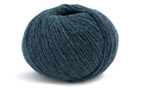 bluish green coloured ball of yarn on a white background