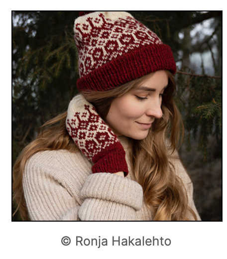 Another angle showing the colourwork knit hat and mittens.  both sets are knit in cream and deep red.
