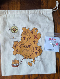 cotton muslin drawstring bag with a treasure map design on a wooden surface