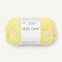 Ball of yellow yarn with a label on a white background