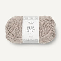 a ball of beige yarn on a white background