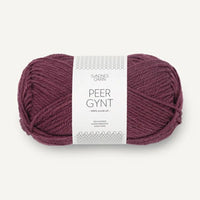 A single skein of Peer Gynt yarn in a deep plum purple color, wrapped with a white paper label, on a light off-white background.