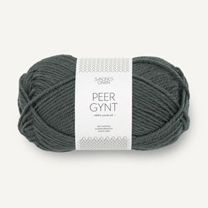 A skein of Peer Gynt yarn in a dark grayish-green color, wrapped with a white paper label that reads 'PEER GYNT'