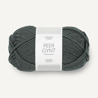 A skein of Peer Gynt yarn in a dark grayish-green color, wrapped with a white paper label that reads 'PEER GYNT'