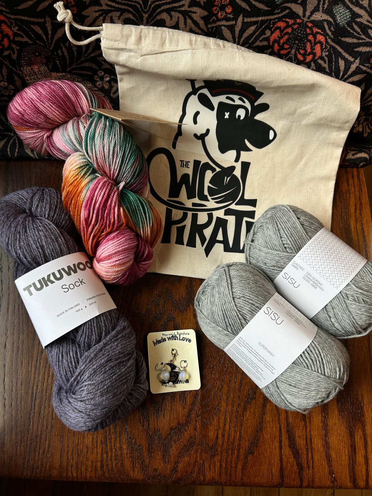 Limited Edition Socktober bundle example containing project bag, stitch markers, alegria, tukuwool sock and sisu yarns.