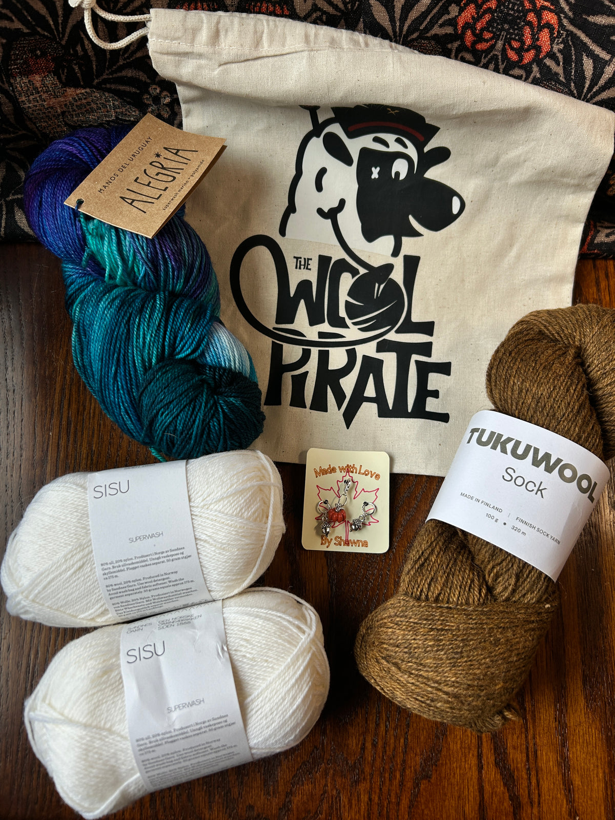 Limited Edition Socktober bundle example containing project bag, stitch markers, alegria, tukuwool sock and sisu yarns.