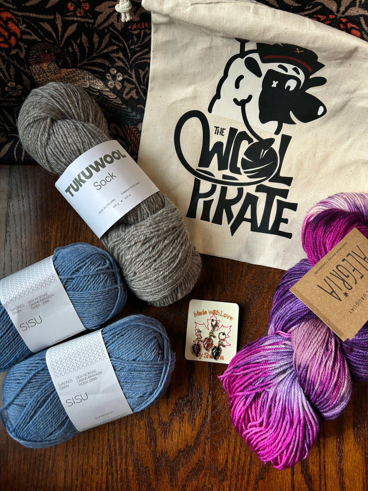 Limited Edition Socktober bundle example containing project bag, stitch markers, alegria, tukuwool sock and sisu yarns.