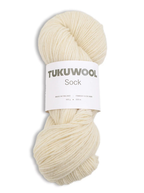 Ball of undyed / white natural yarn against a white background