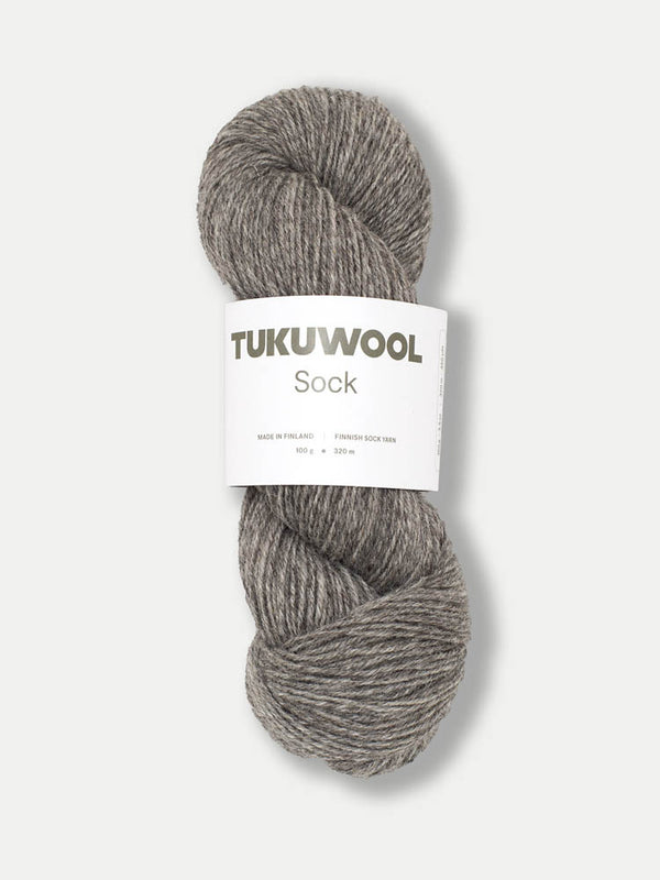 skein of grey tweed like yarn against a white background