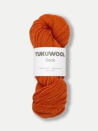 skein of orange yarn against a white background