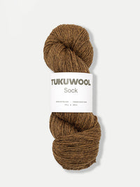 skein of brown tweed like yarn against a white background