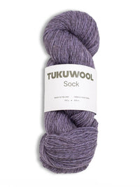 skein of purple tweed like yarn against a white background