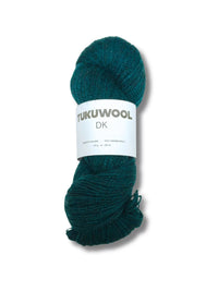A skein of dark teal green yarn with a white paper label reading 'TUKUWOOL DK' on a white background.
