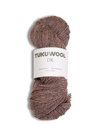 A skein of Tuku Wool DK yarn in a dusty mauve-brown color, wrapped with a white paper label, on a white background.