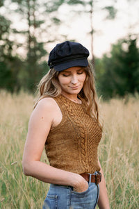 image of a knit sleeveless top being worn on a woman in a wild grass field