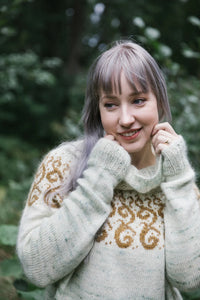 a woman wearing a knit colourwork sweater outdoors