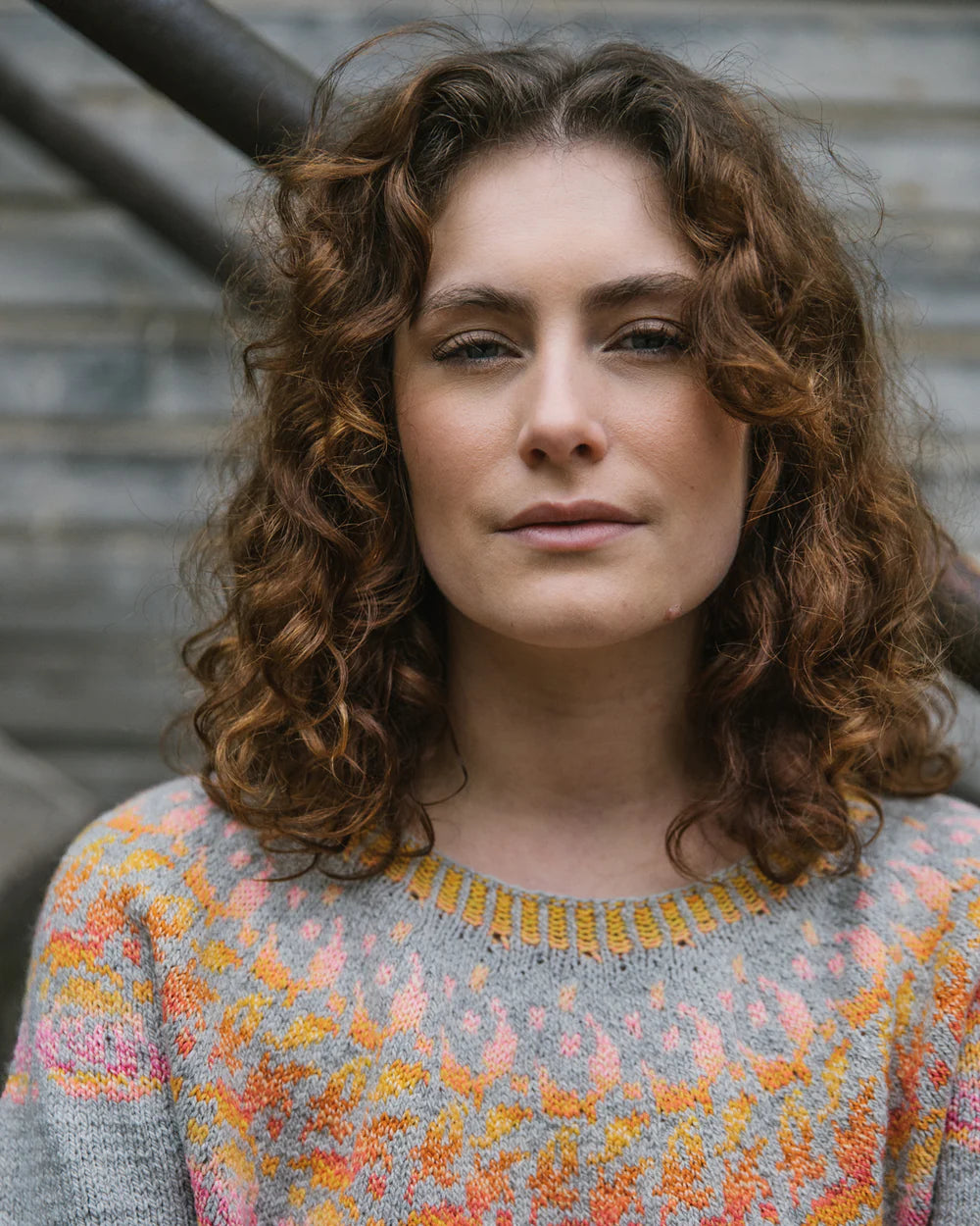 the designer wearing a colourwork sweater with a closeup of the yoke