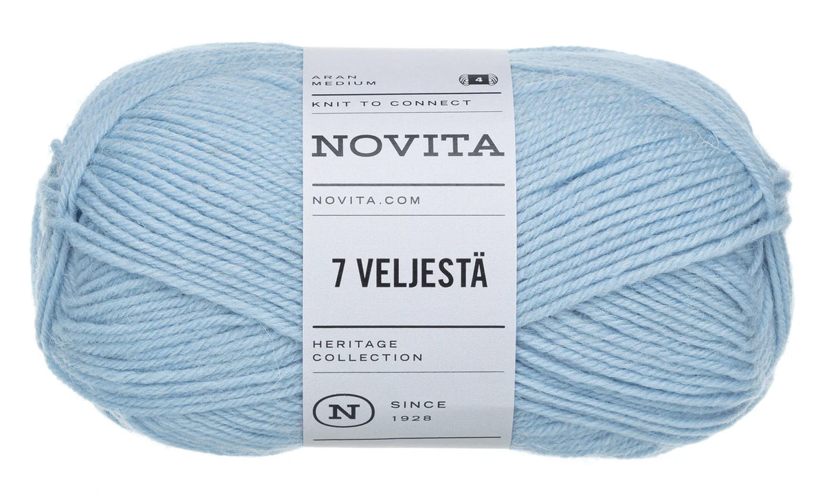 A skein of light blue yarn with a white paper label reading 'NOVITA' and '7 VELJESTÄ', photographed on a plain white background.