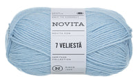 A skein of light blue yarn with a white paper label reading 'NOVITA' and '7 VELJESTÄ', photographed on a plain white background.